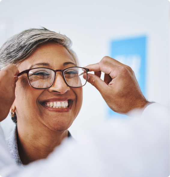 Patient smiling while being fitted for glasses